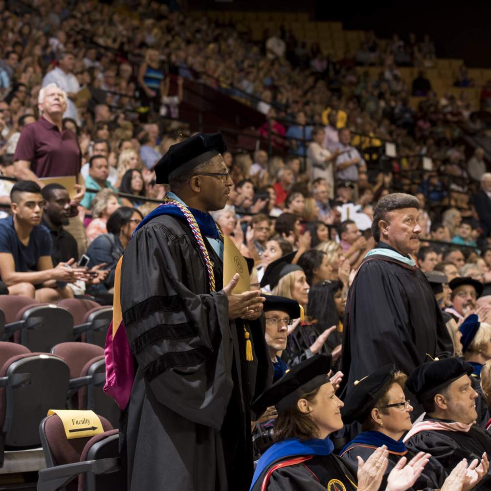 Veterans among the students, faculty, staff, and guests are honored for their service at a Summer 2016 commencement ceremony at Texas State University, some of which wear an optional cord of red, white and blue.