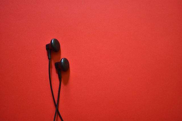Earbuds on a red background