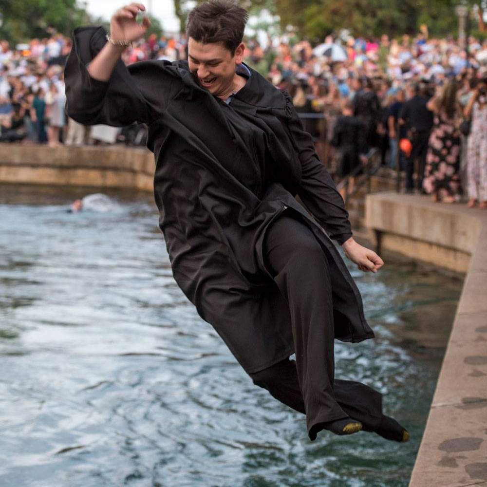 graduate jumps backwards into the river