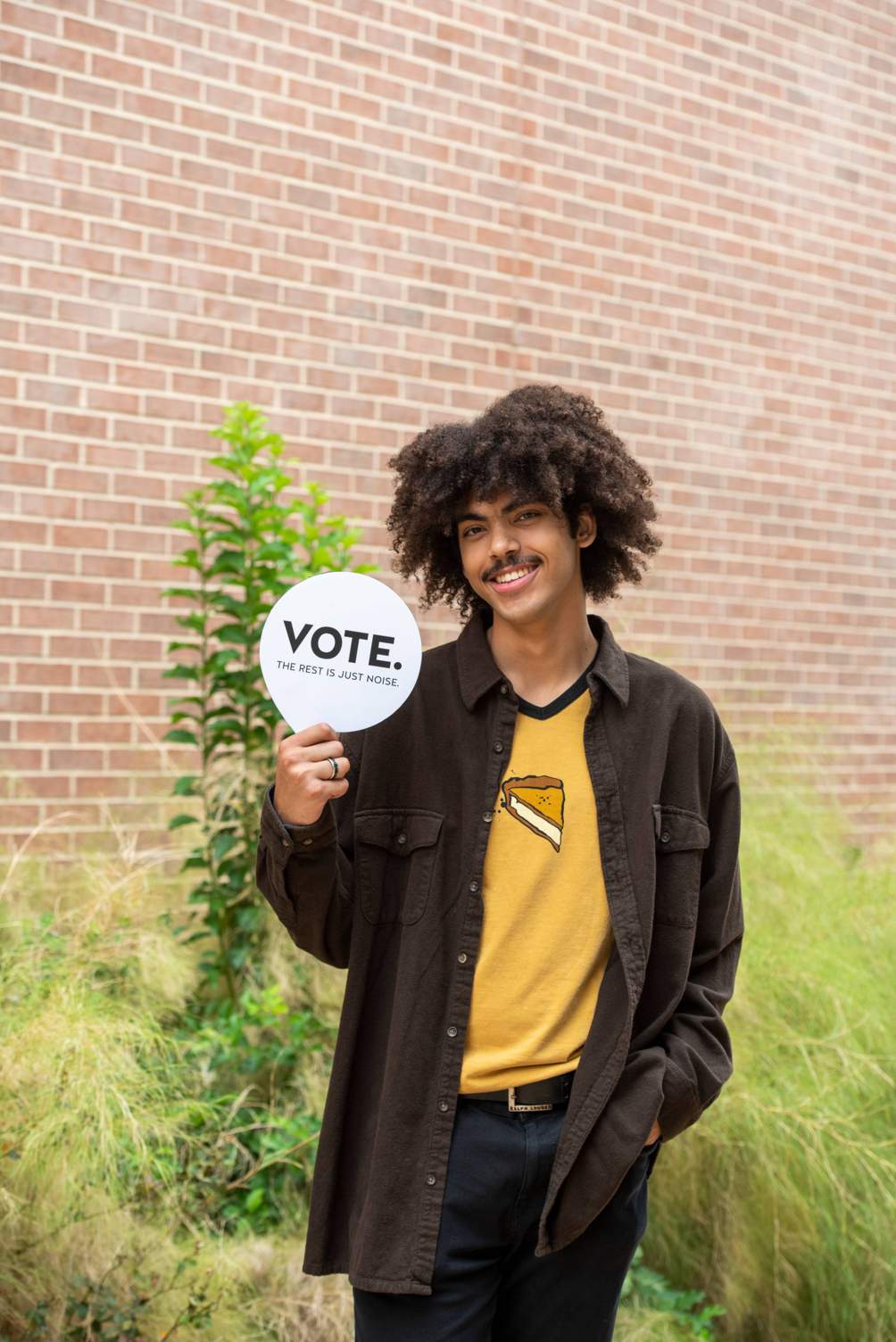 Samuel Nieves holding a "vote" sign