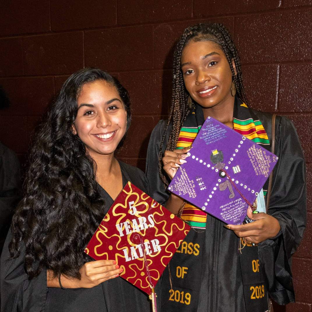 Two graduates with their caps