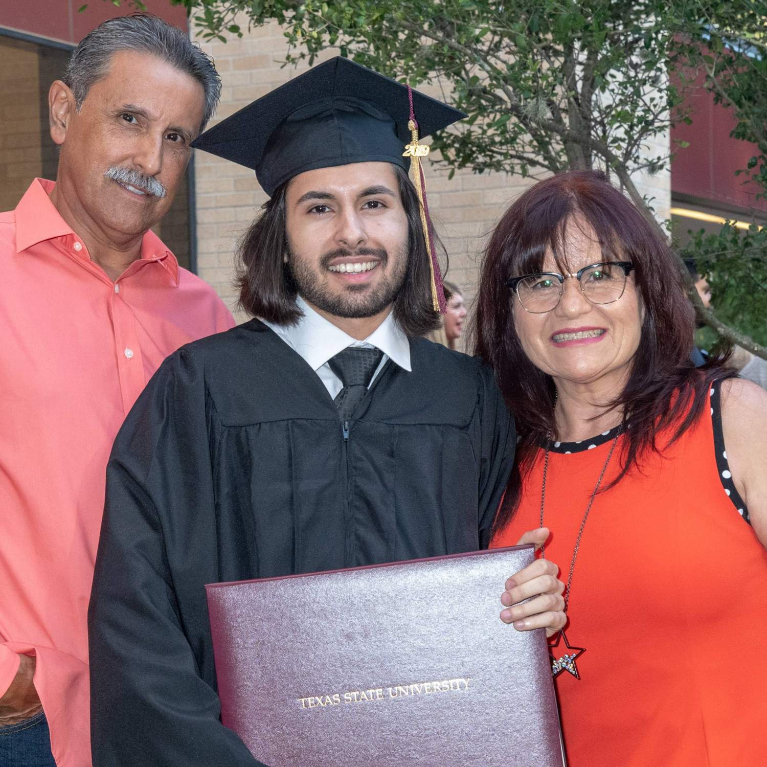 Graduate with his parents