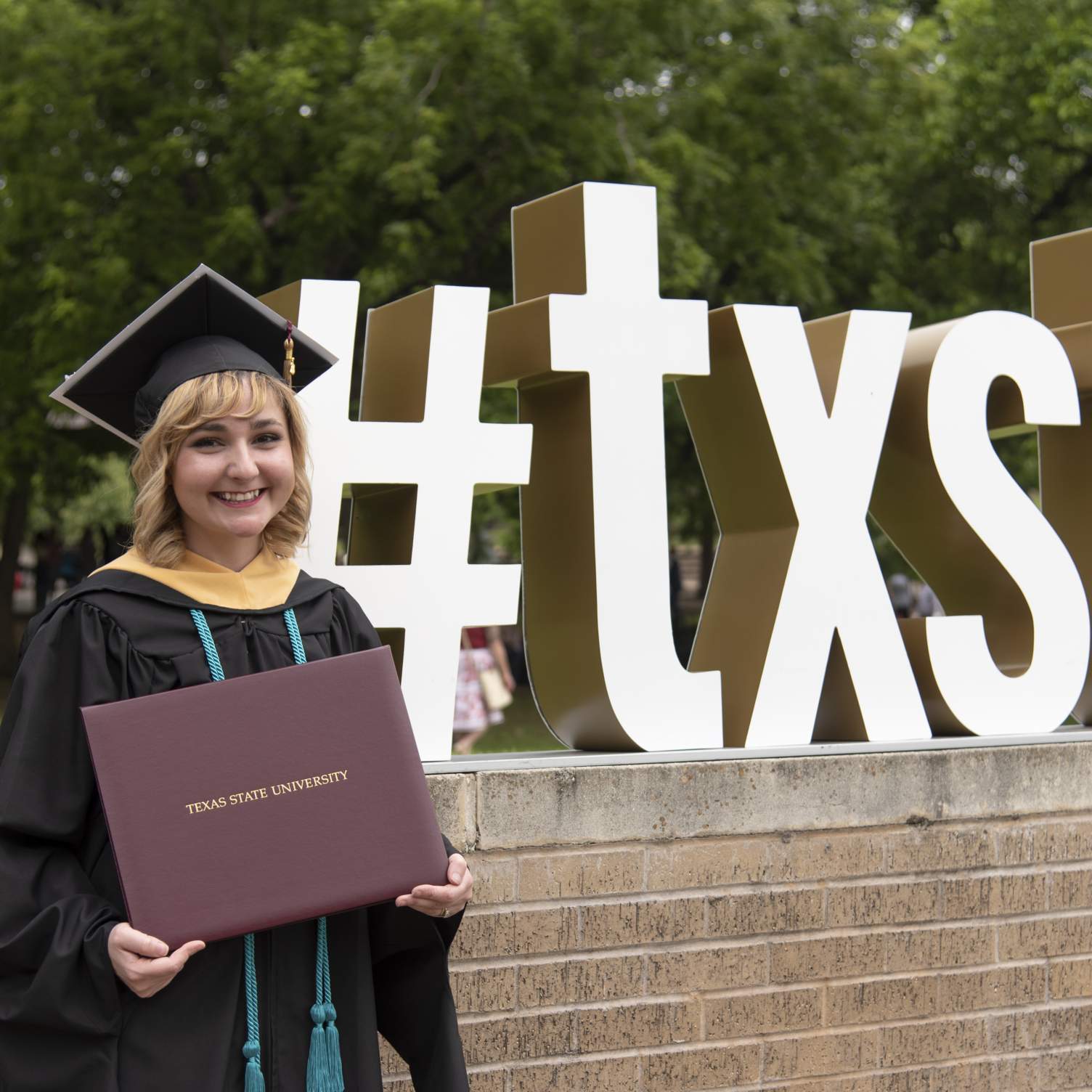 #txst Master's graduate with diploma