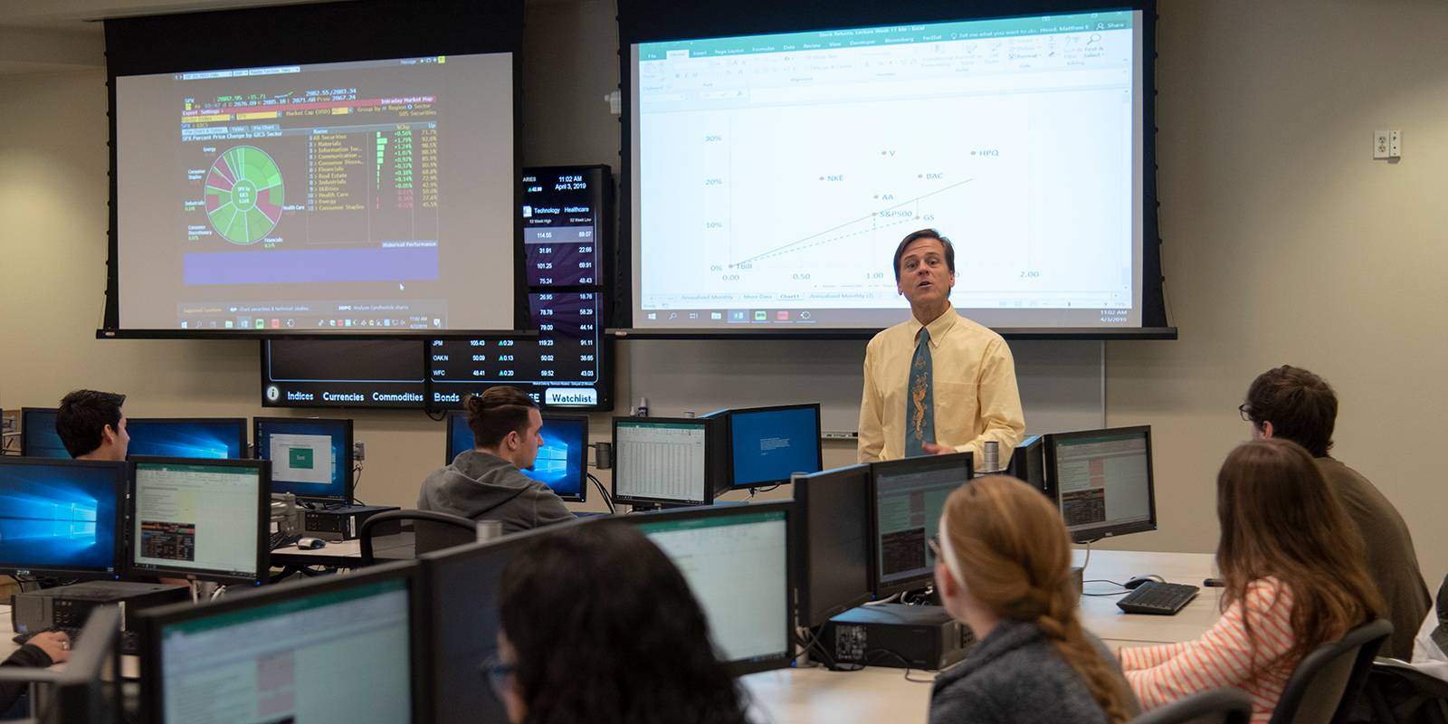Finance professor teaching in trading lab