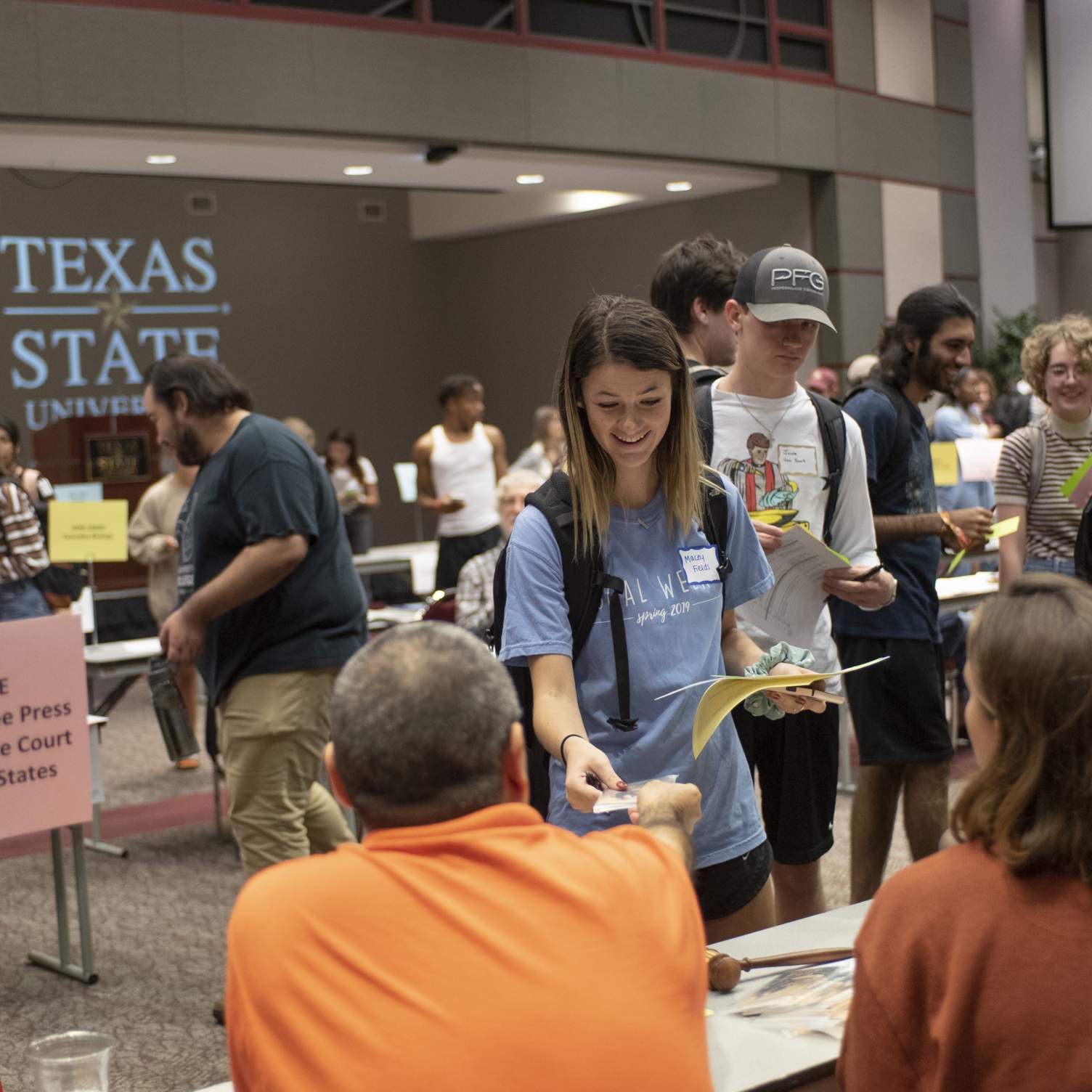 Student receiving a pocket constitution at Meet the Professor Fall 2019