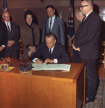 president LBJ signs the higher education act on the texas state campus