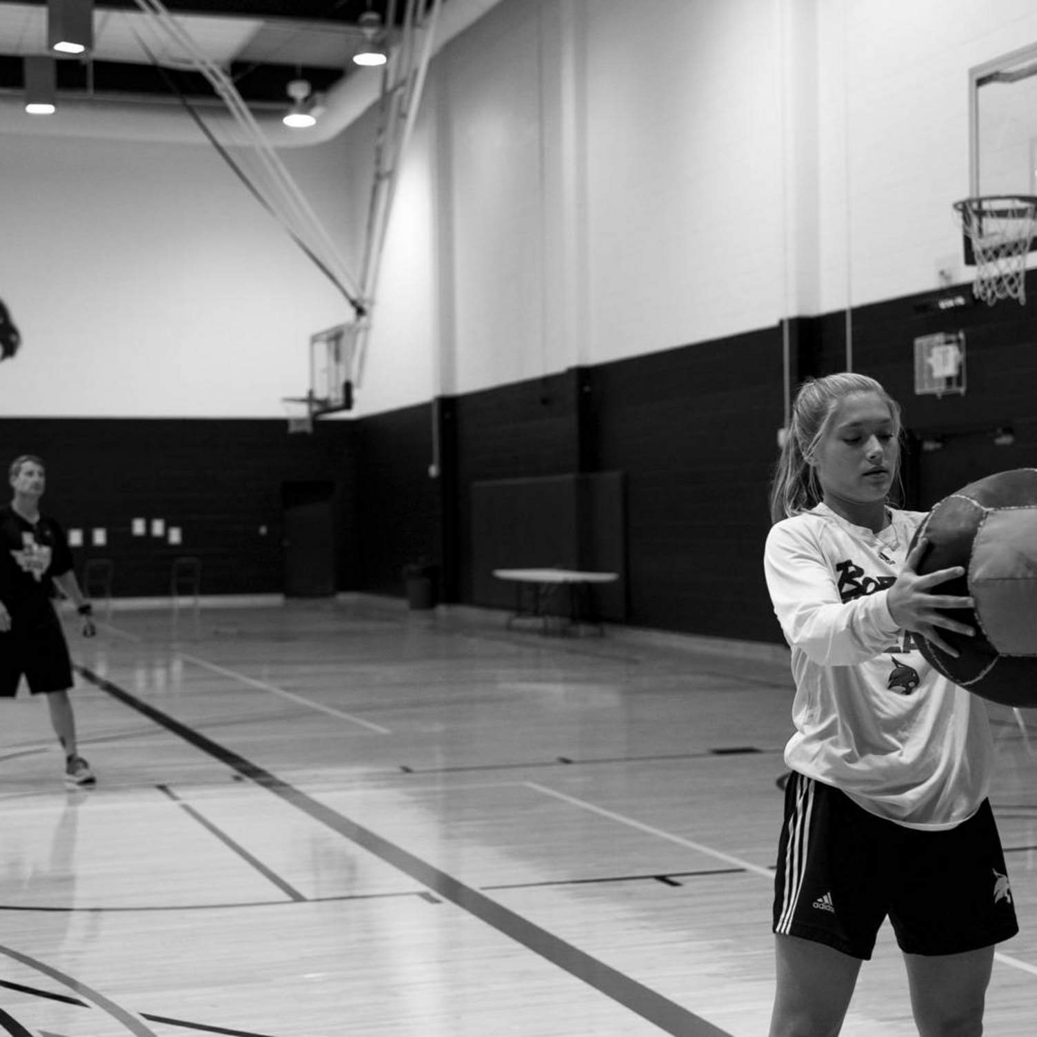 basketball player preparing to throw the ball behind her back
