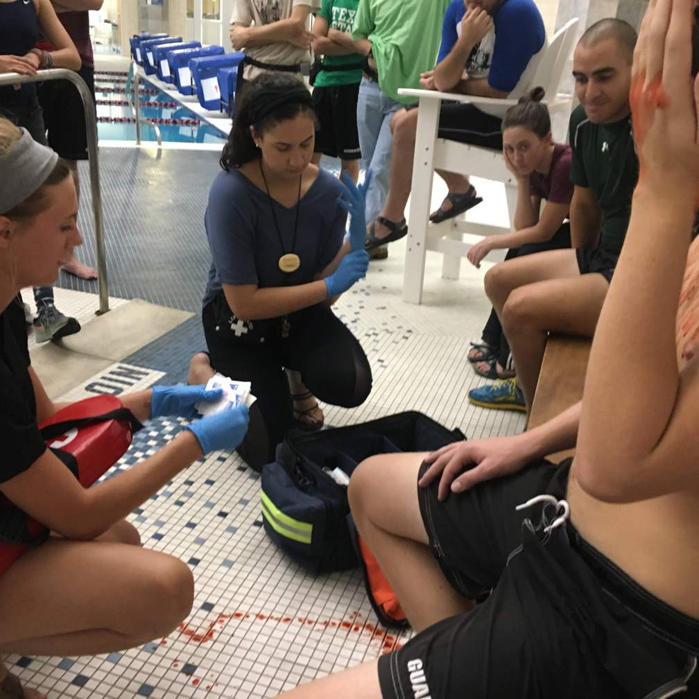 picture of lifeguards treating a pretend head wound during a drill