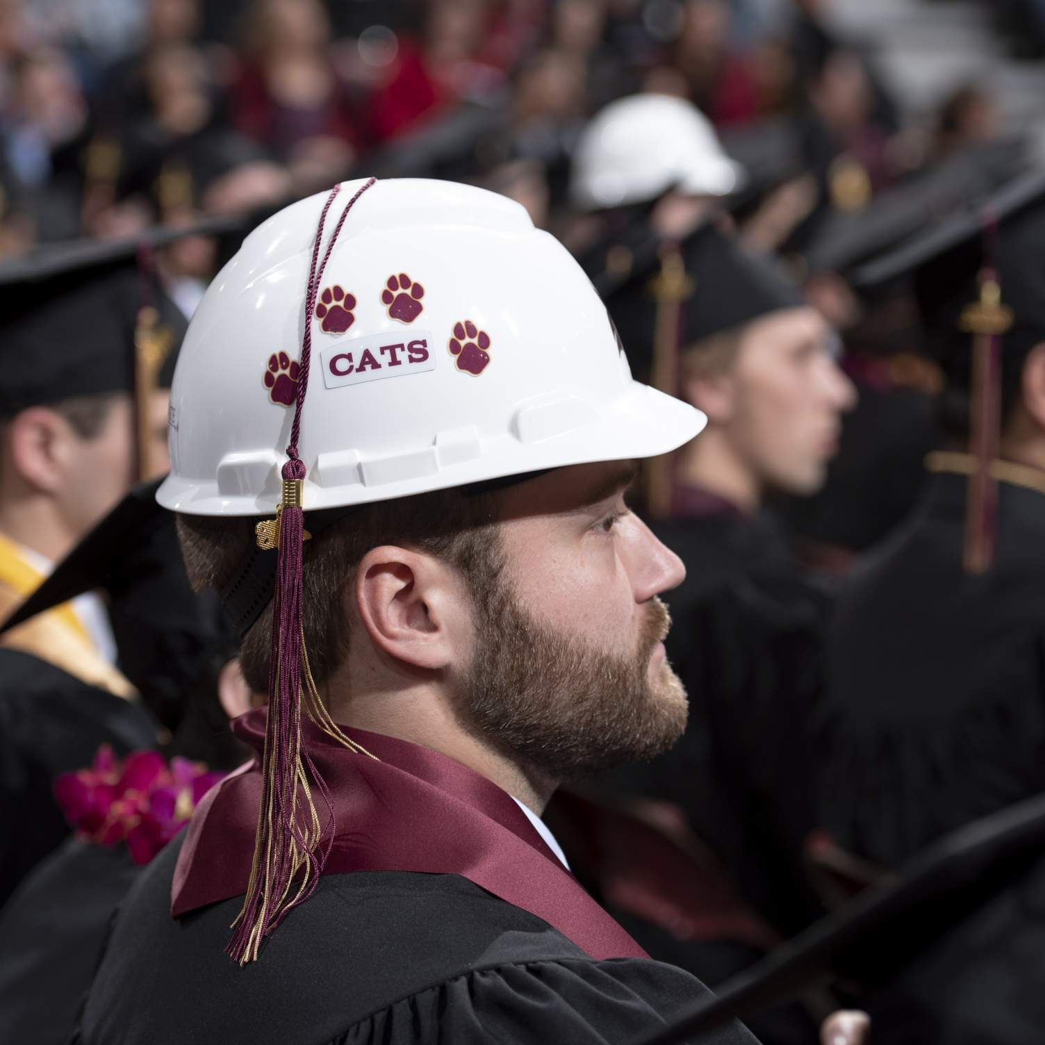 Science and Engineering graduate wearing hard hat as graduation cap