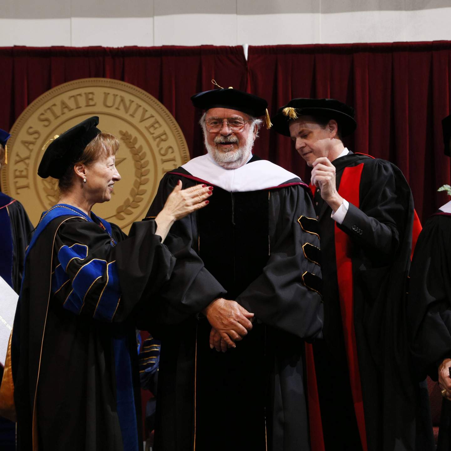 William D. Wittliff hooded by President Trauth and Provost Bourgeois 