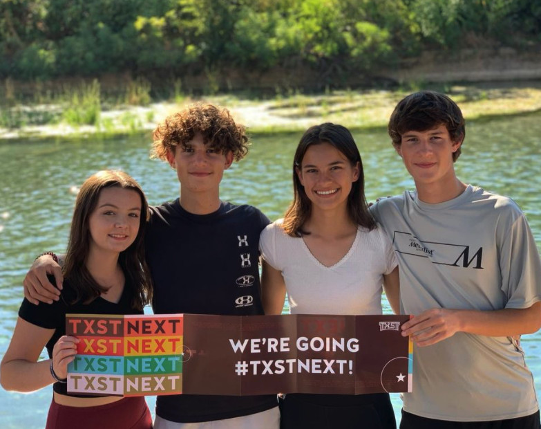 Four future Bobcats pose with a banner that reads “We’re going #TXSTnext!”