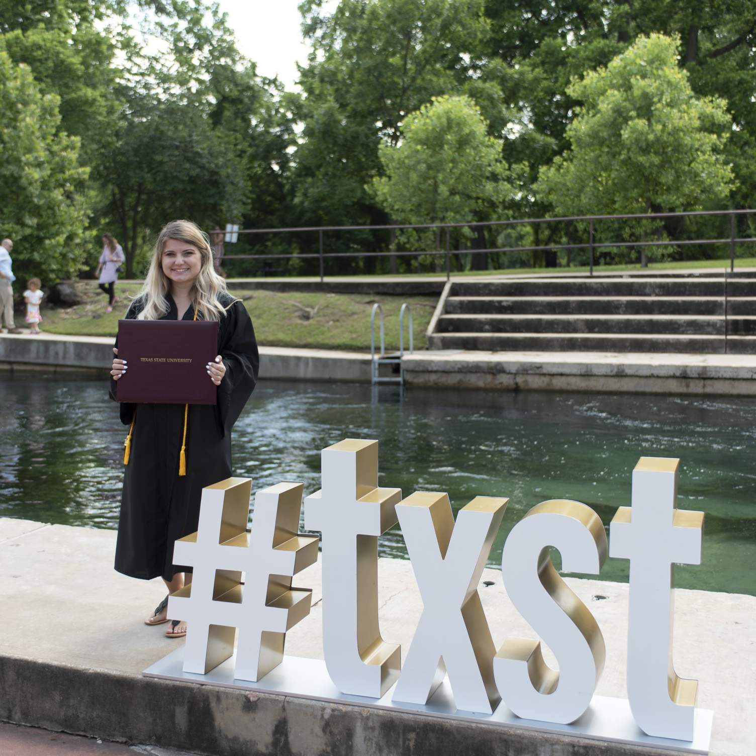#txst graduate with diploma