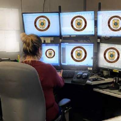 police dispatcher at computer screens