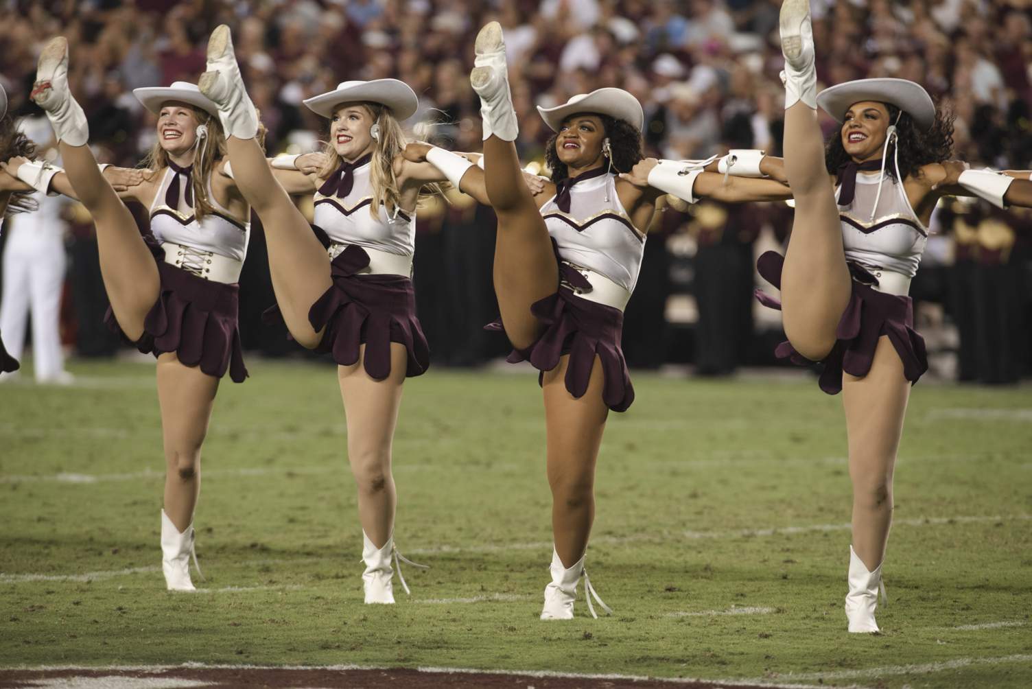 strutters in a kick line at a TXST football game 