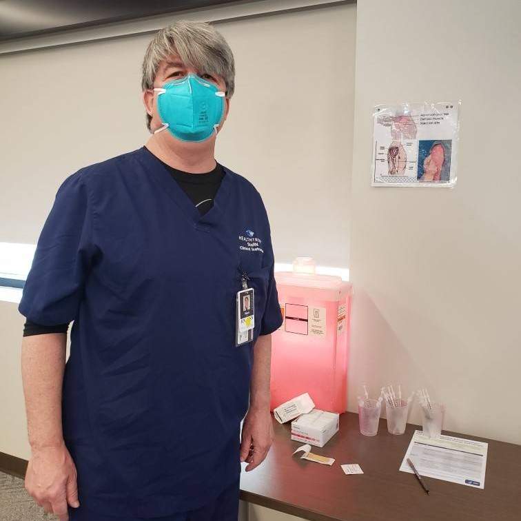 man in medical scrubs and mask