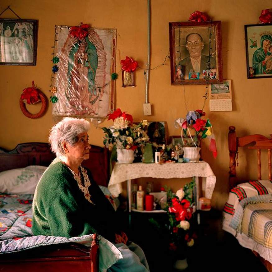 Grandmother sitting on bed