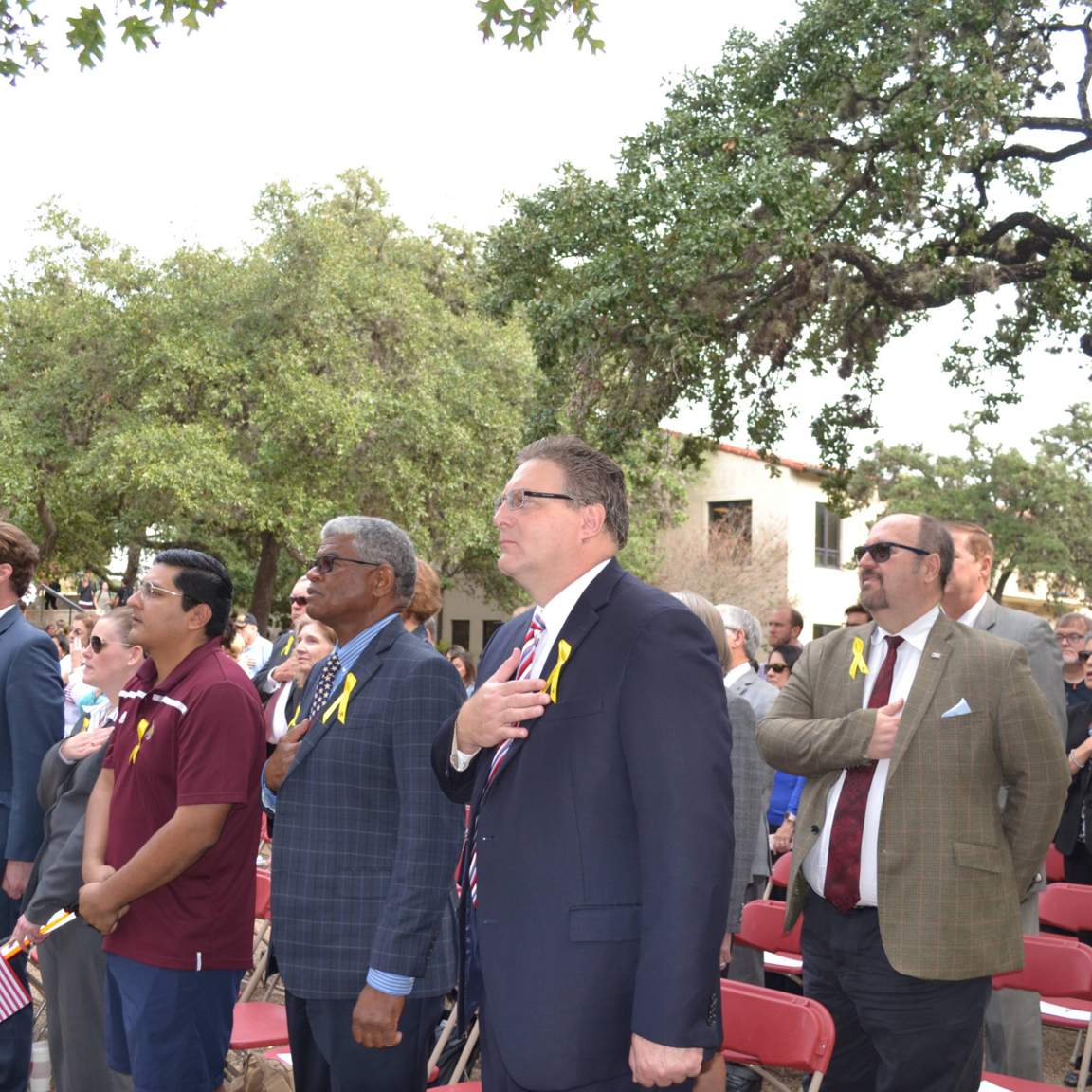Veterans, Faculty and Guests stand for the National Anthem