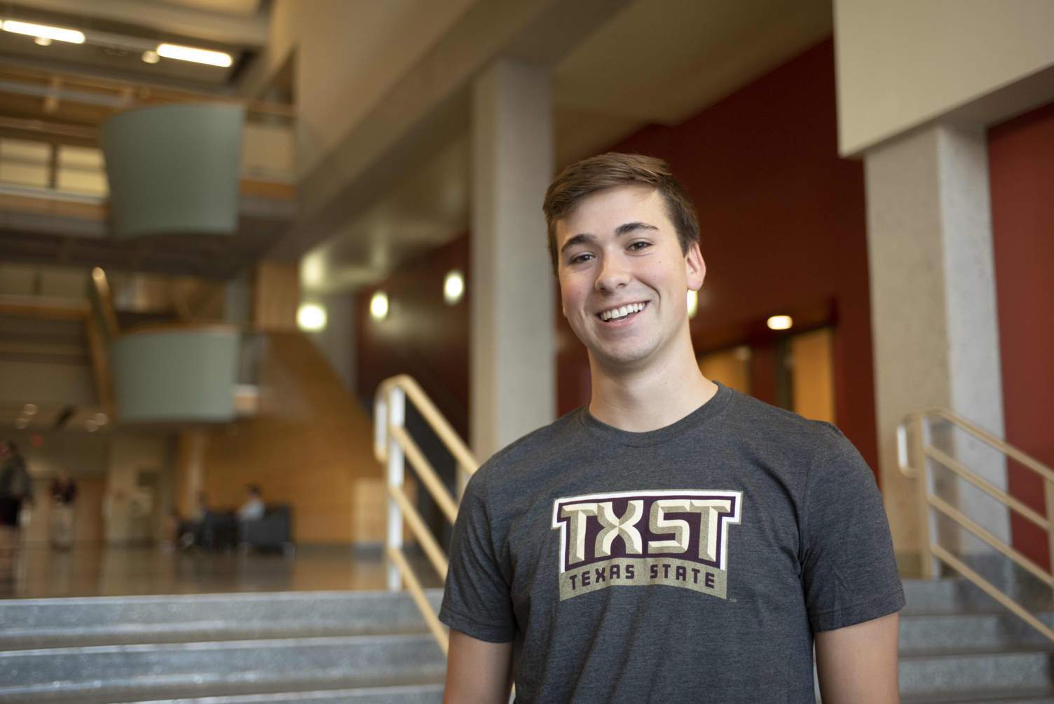 person stands in texas state shirt