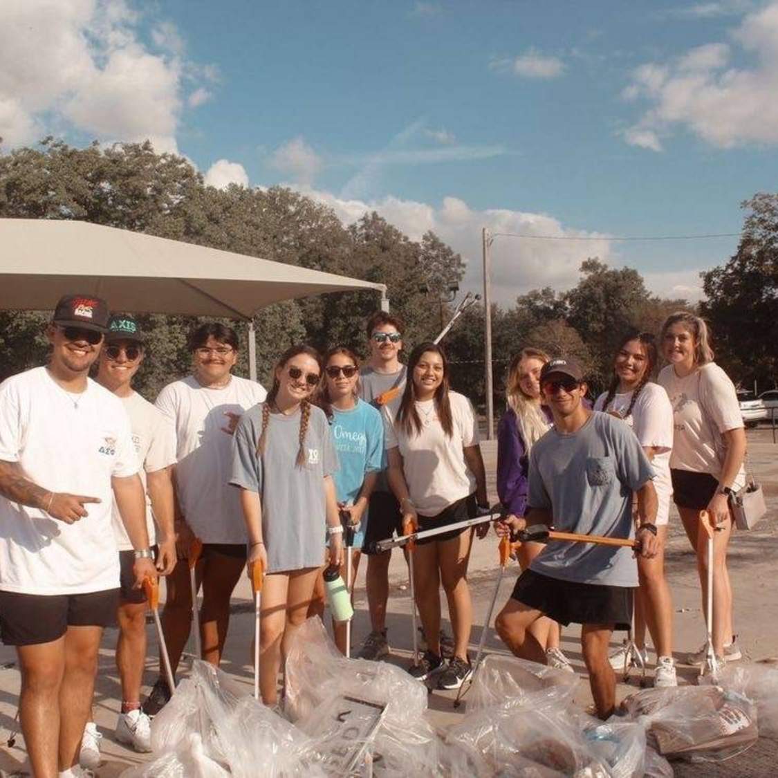 sorority and fraternity members with gathered trash