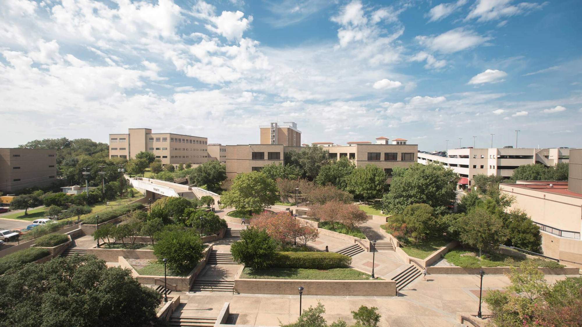 Wideshot view of Texas State Univiersty. Sky is blue with clouds. 