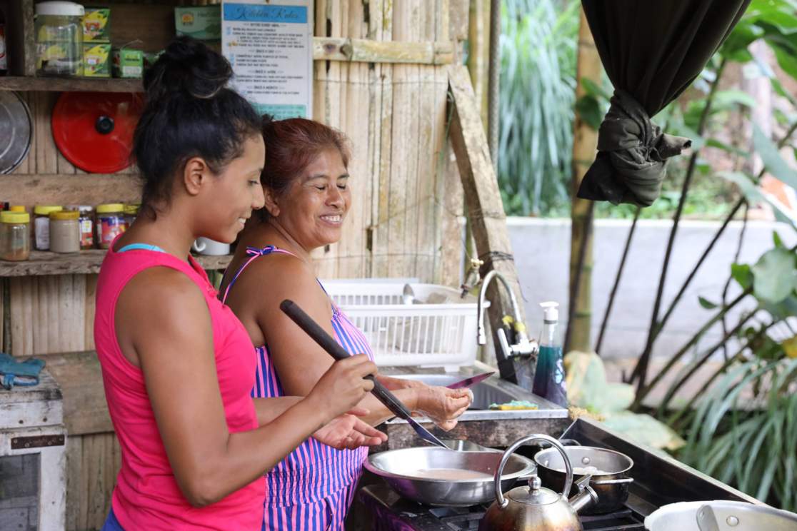Two women cook in the Bamboo House's kitchen