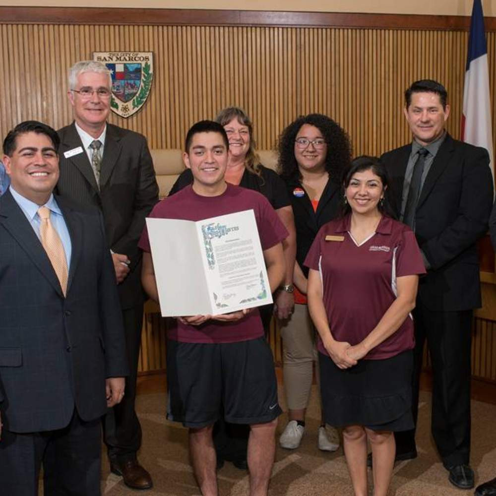 San Marcos Mayor Daniel Guerrero and council members Shane Scott and John Thomaides recently proclaimed May 22 as “Pack It Up and Pass It On Day” in San Marcos, encouraging all San Marcos residents to support this unique “green” move out program at Texas State University that diverts seven tons of gently used items for low-income San Marcos families to reuse. Texas State residence hall students donate clothing, office supplies, small electronics and more during spring move out. Guerrero announced that San Marcos residents can do their own “spring cleaning” and bring items to donate to the distribution May 18-21 between 9 a.m. and 4 p.m. to the LBJ Student Center ballroom. Pictured, from left to right, are Kim Porterfield, Texas State University Community Relations; Mayor Guerrero; Freeman “Hensley” Cone; San Marcos CISD; Juan Miguel Arredondo, Texas State Community Relations student worker; Julie Hollar, Youth Services Bureau; Mariana Zamora, Texas State Community Relations student worker; Maggie Gillespie, Texas State Community Relations; and council members Scott and Thomaides. For more information, visit www.txstate.edu/community. (Photo by Don Anders) 