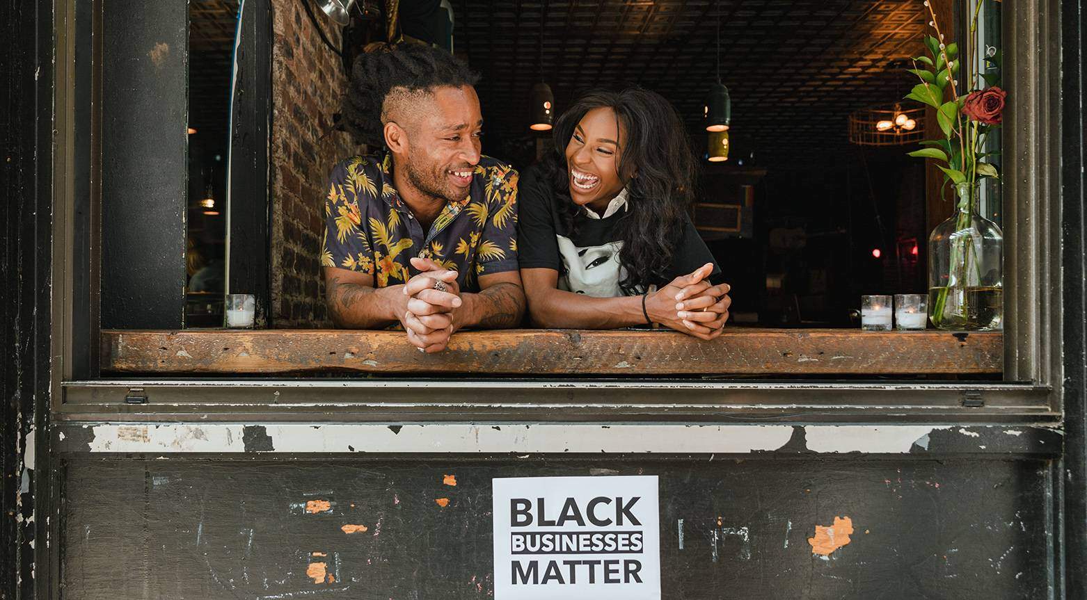 two black business owners smiling in business