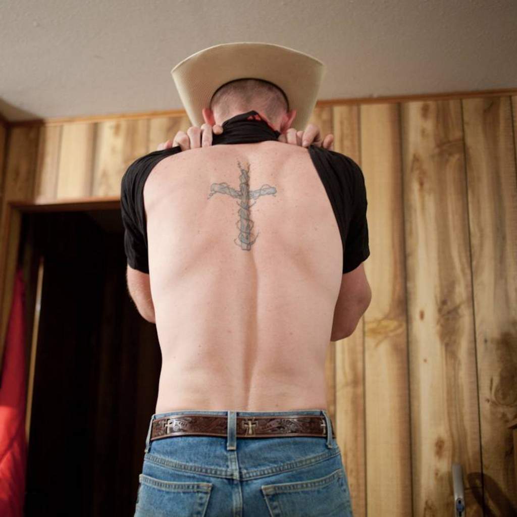 Student Work Color Photo of a Man's Back with a Cross Tattoo