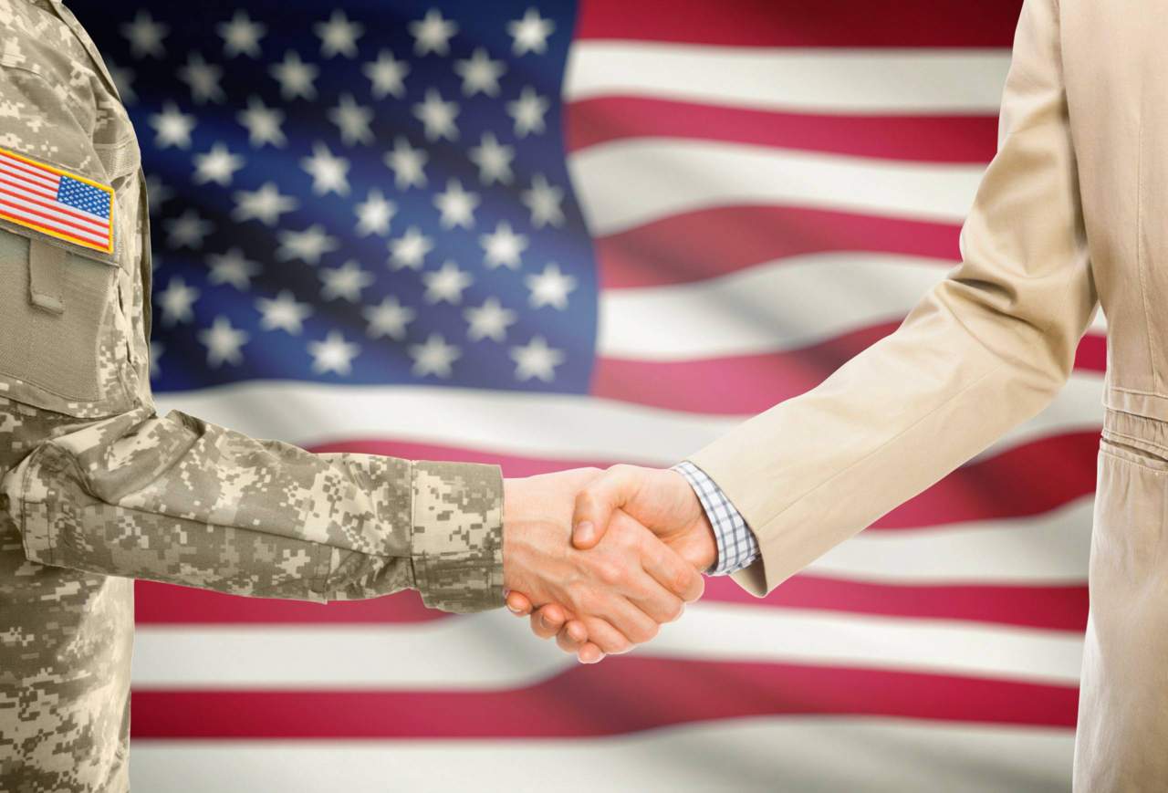 Veteran handshake in front of American flag
