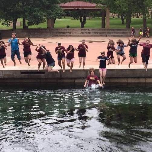 SAHE students jumping in river at Sewell Park