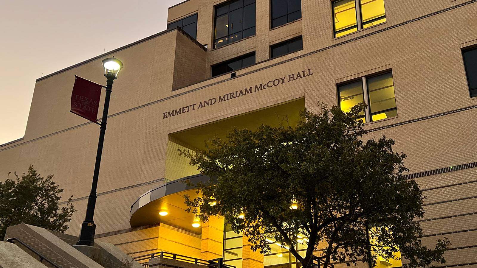 Main entrance to McCoy Hall at Texas State University at dusk