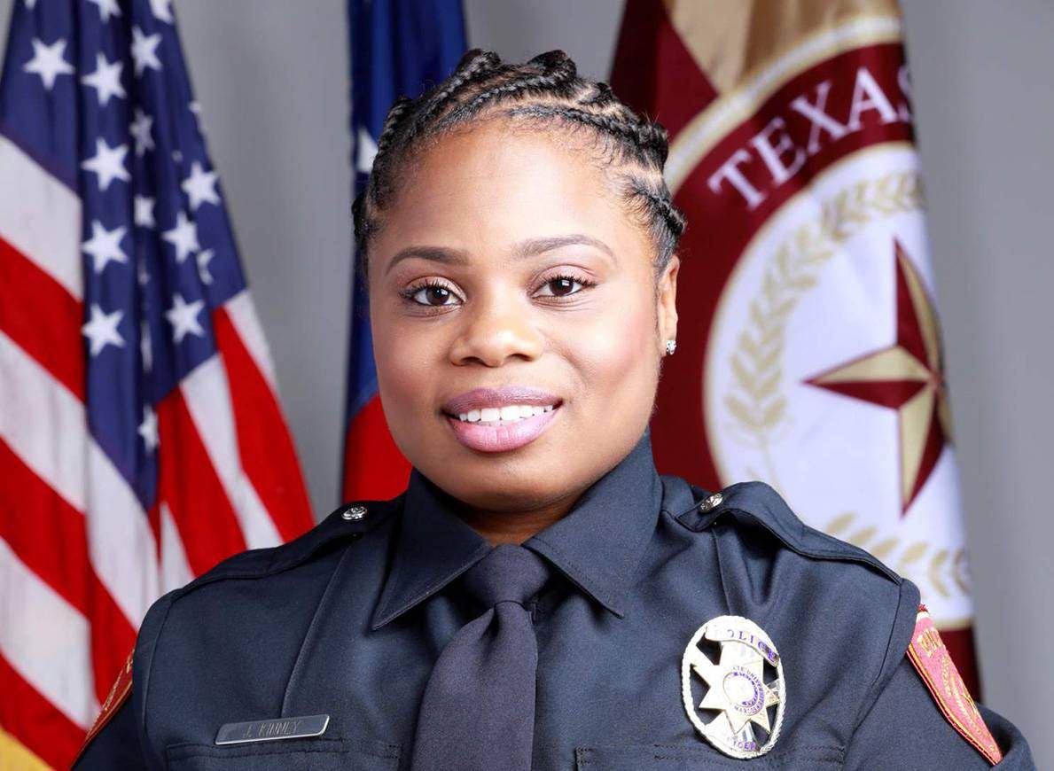 black female police officer smiling 
