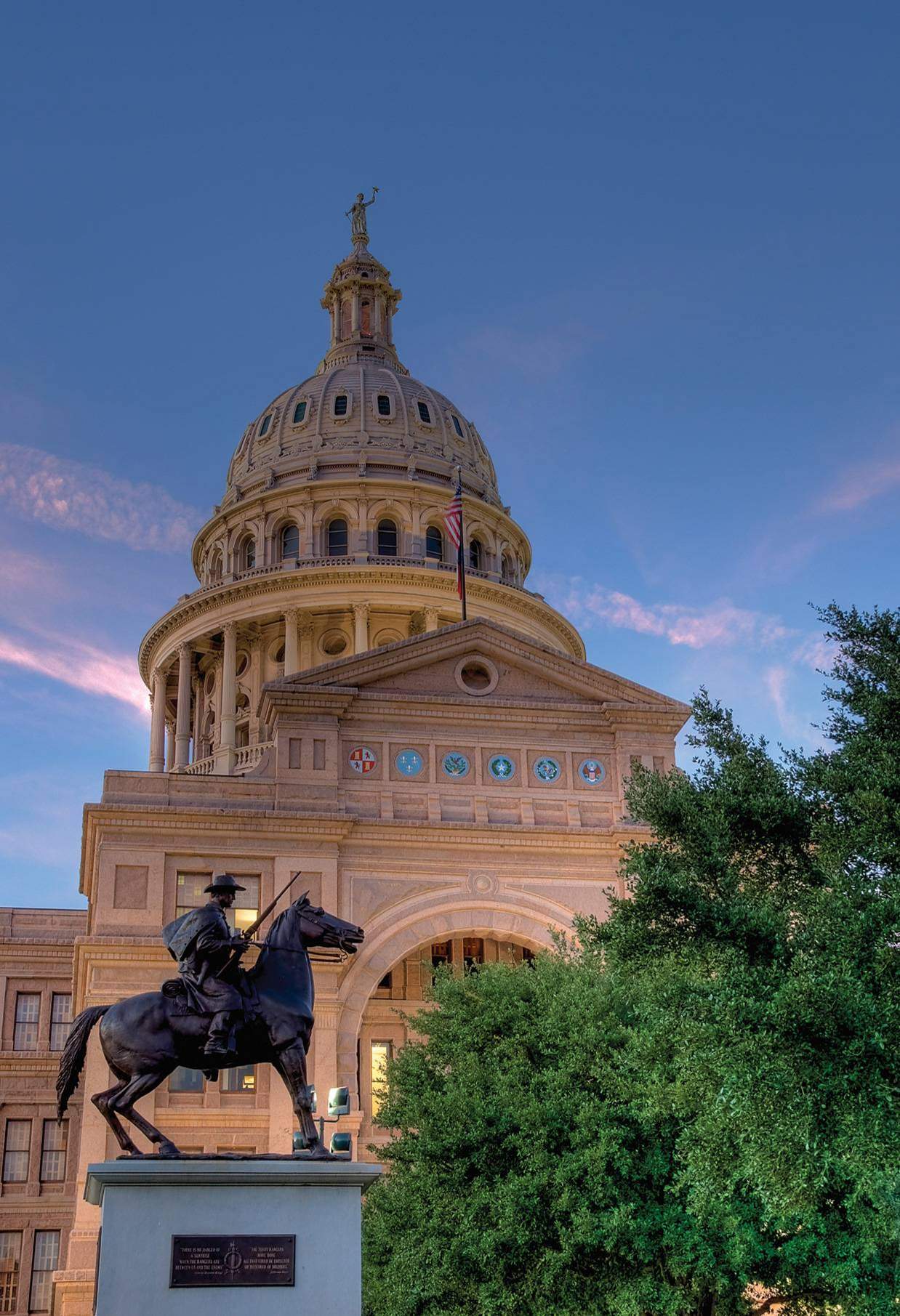 outside the texas capital with a statue of a horse