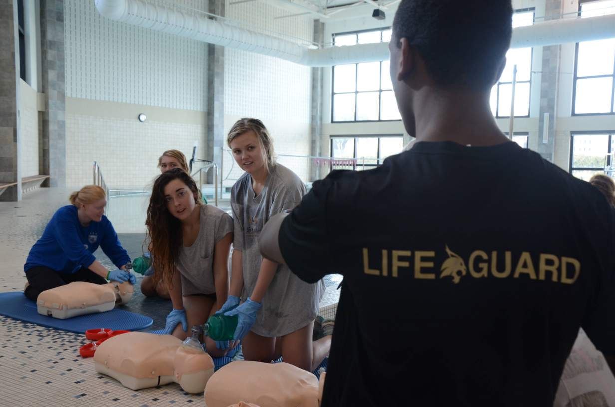 Lifeguard instructing CPR