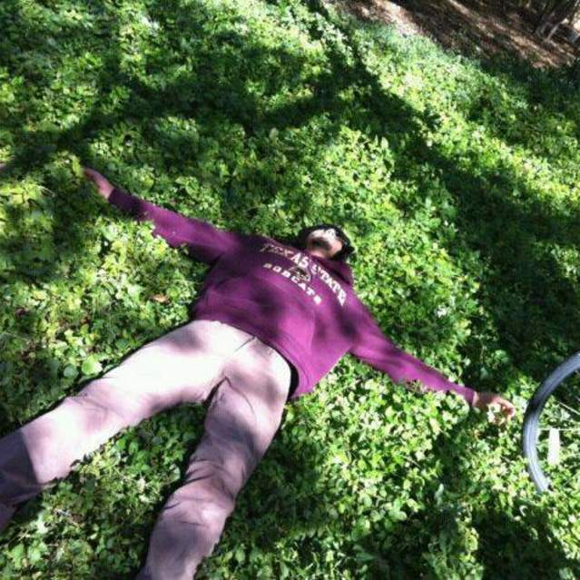 Student laying in grass