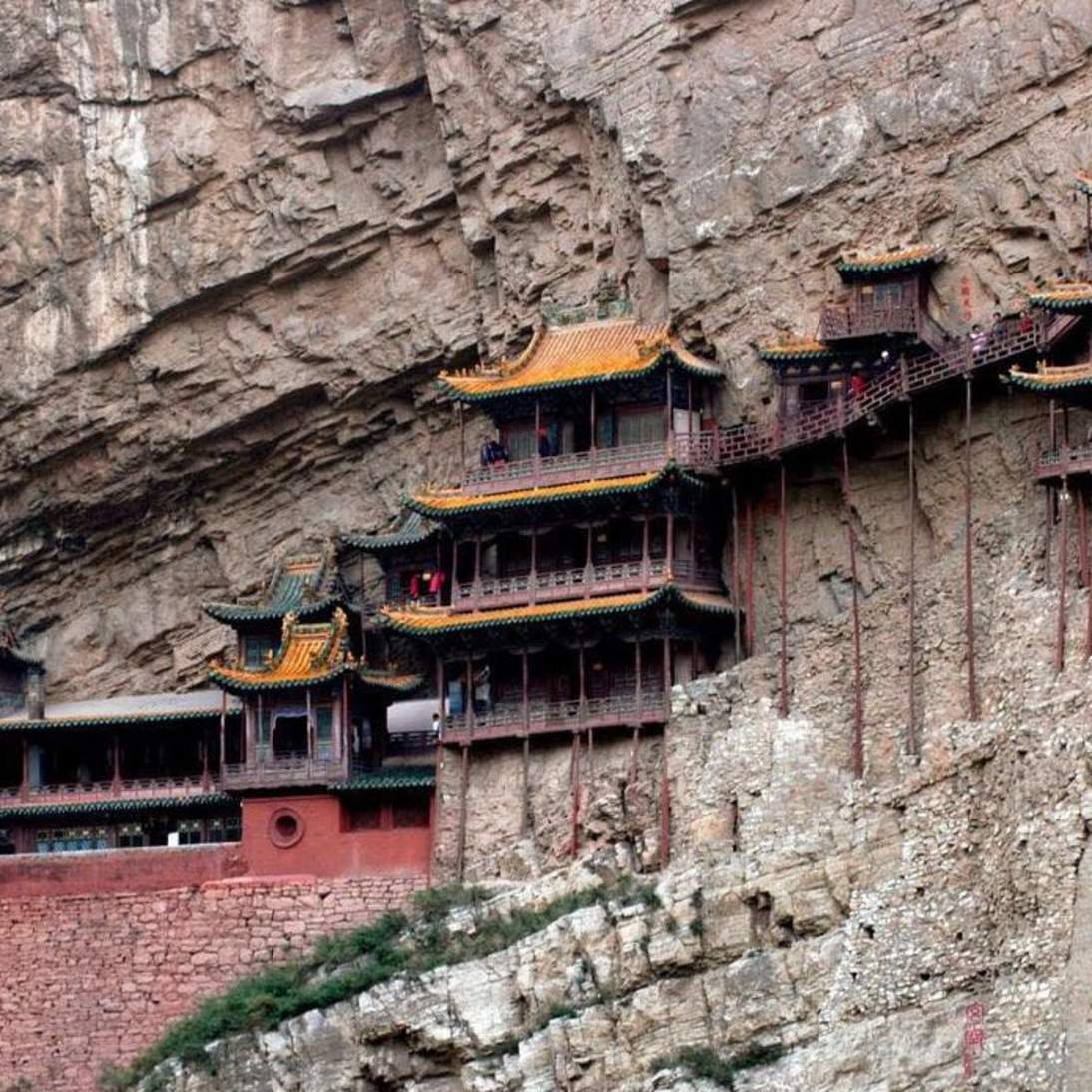 Image of buildings attached to a cliff face