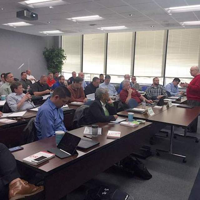 Instructor Chris Hartung, President & CEO of Hartung Associates delivers a presentation on recruitment and selection processes and procedures to participants in the Arlington, TX CPM Program.