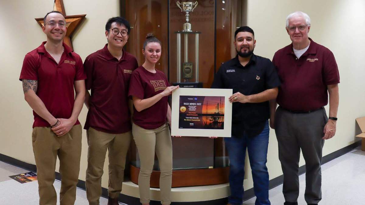 texas state students and faculty holding an award