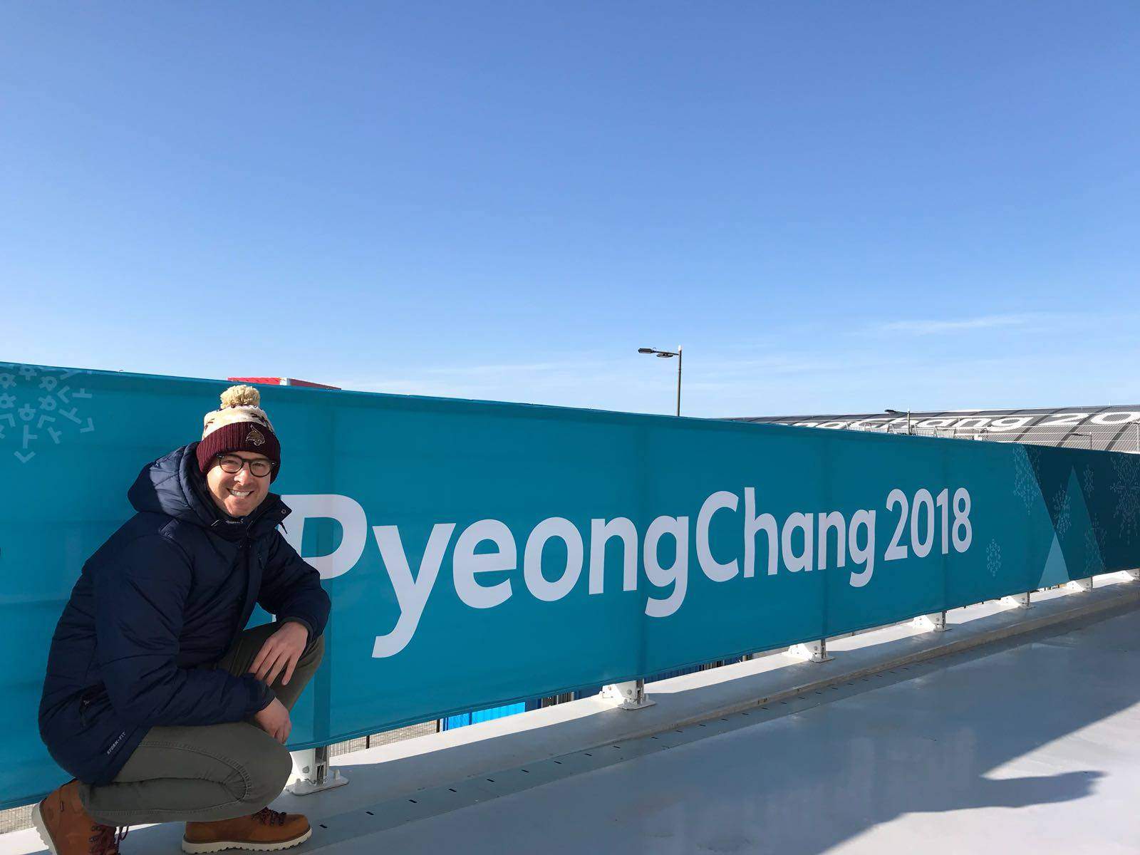 man in front of sign that read PyeongChang 2018