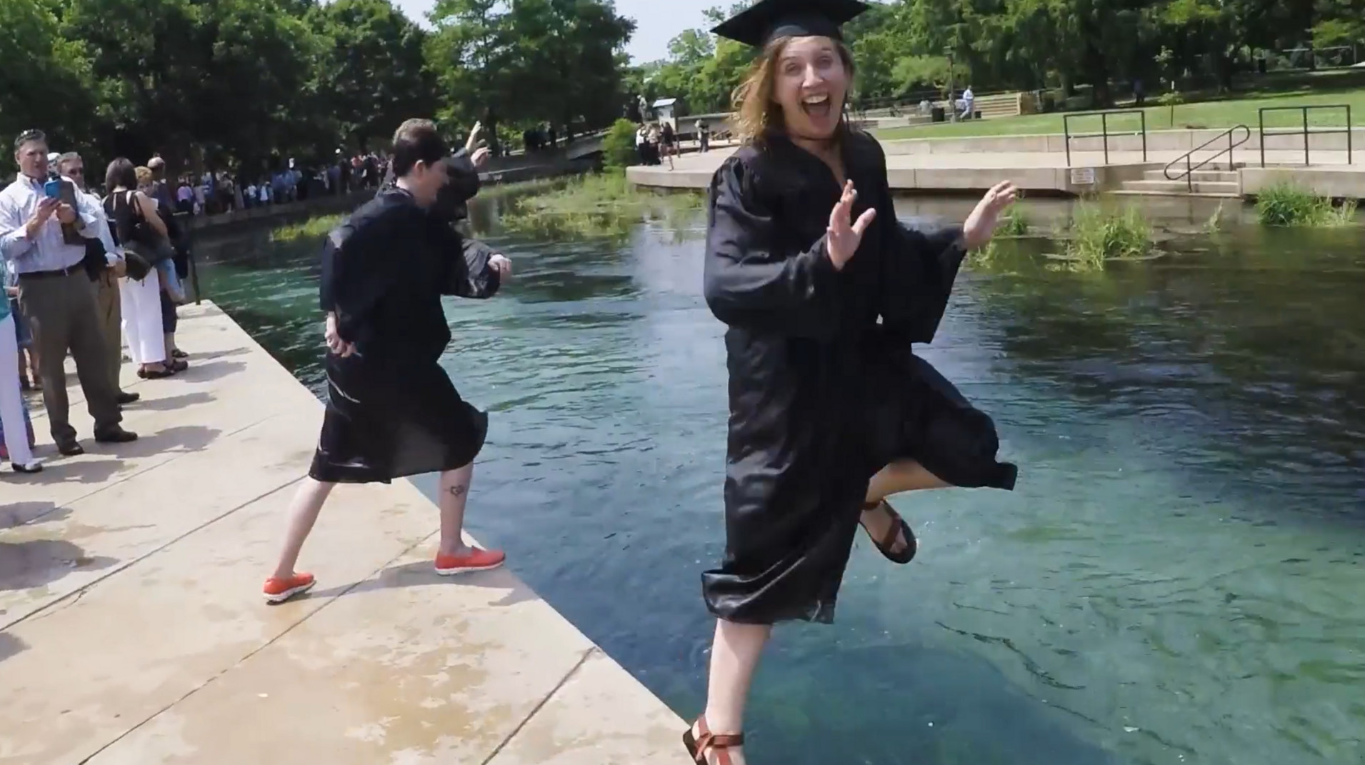 Graduate walking the stage and jumping in the river