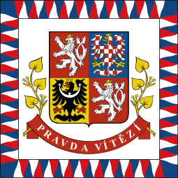 Coat of arms with national motto "Pravda vítězí" (Truth prevails) and leaves of linden tree.