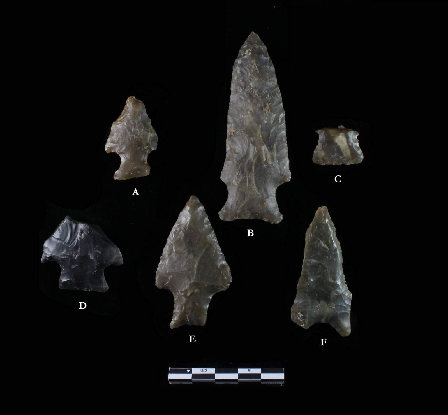 photo of lithic artifacts with black background