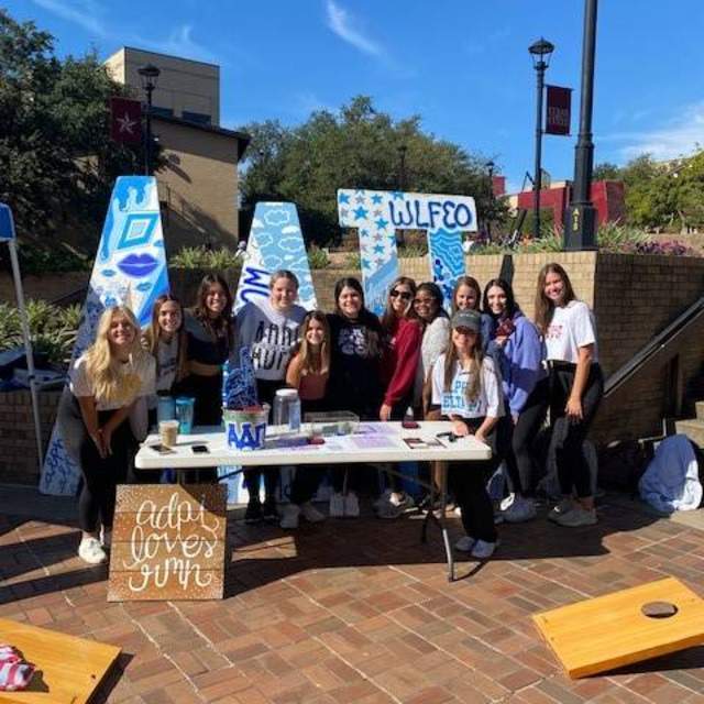 adpi member at booth on campus
