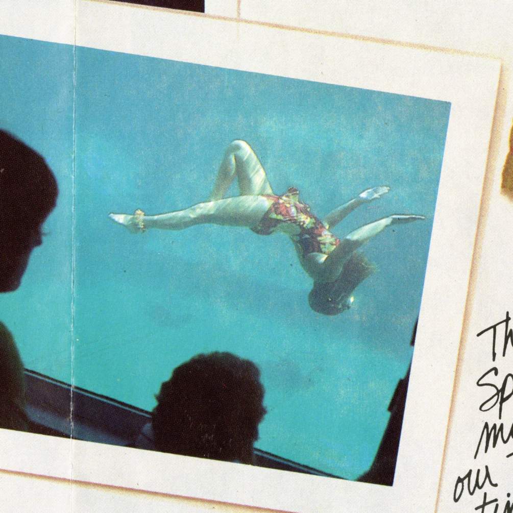 a mermaid does a back flip in a historic photo