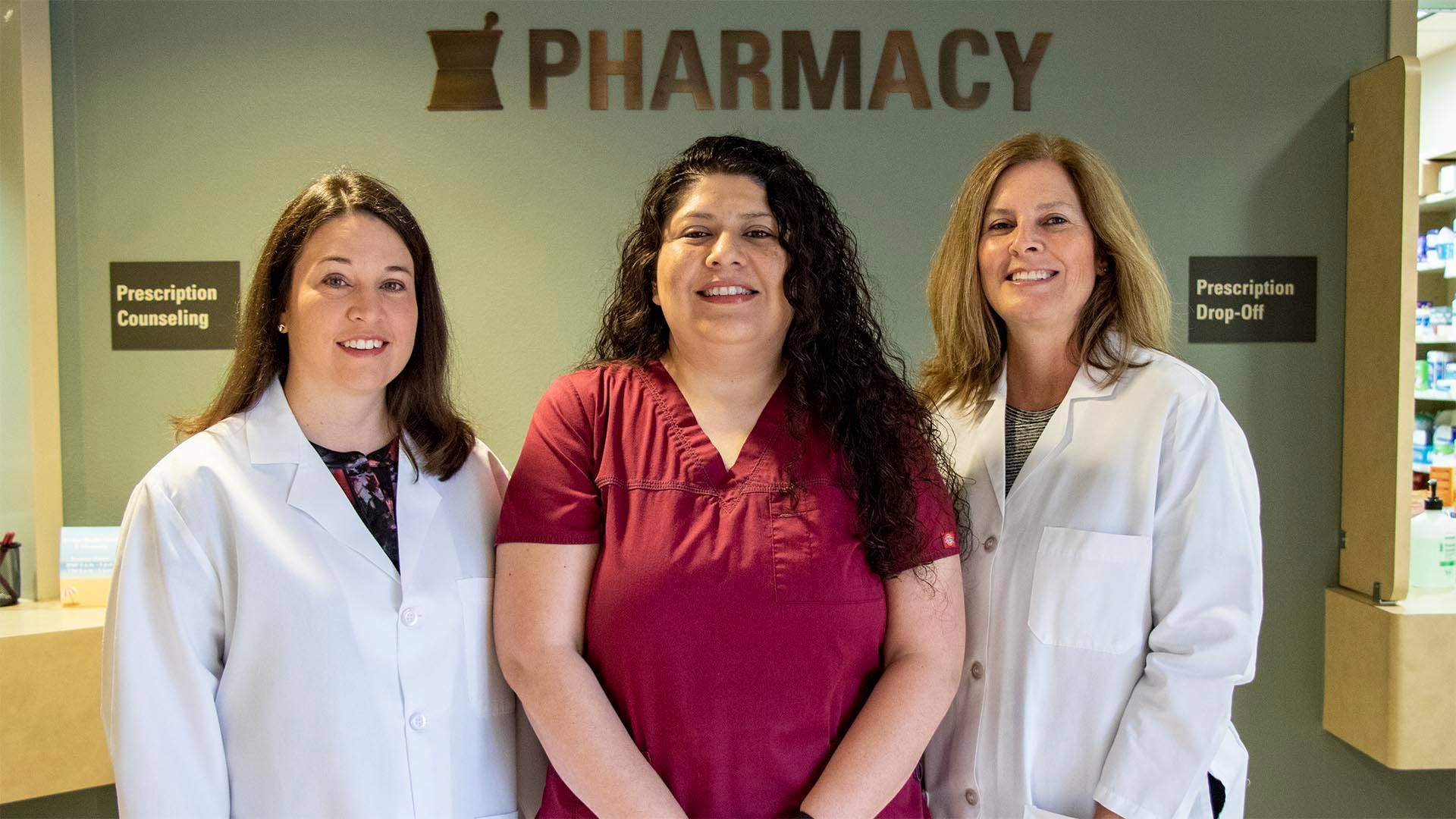 Pharmacists and Pharmacy tech in Front of the Pharmacy.
