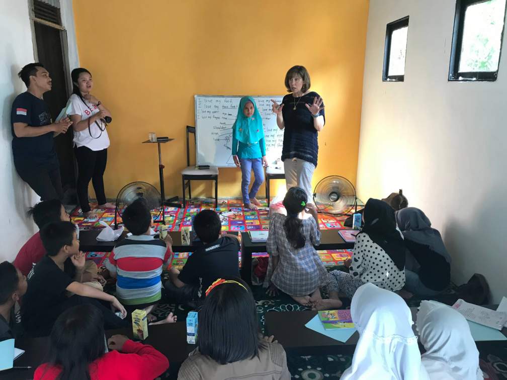 Dr. Assaf teaches a literacy lesson to elementary aged children and student teachers at the Rumah Pintar EFCT House in the local village of Kubu Raya. 