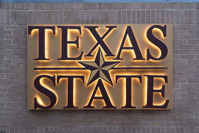 txst sign in brick wall