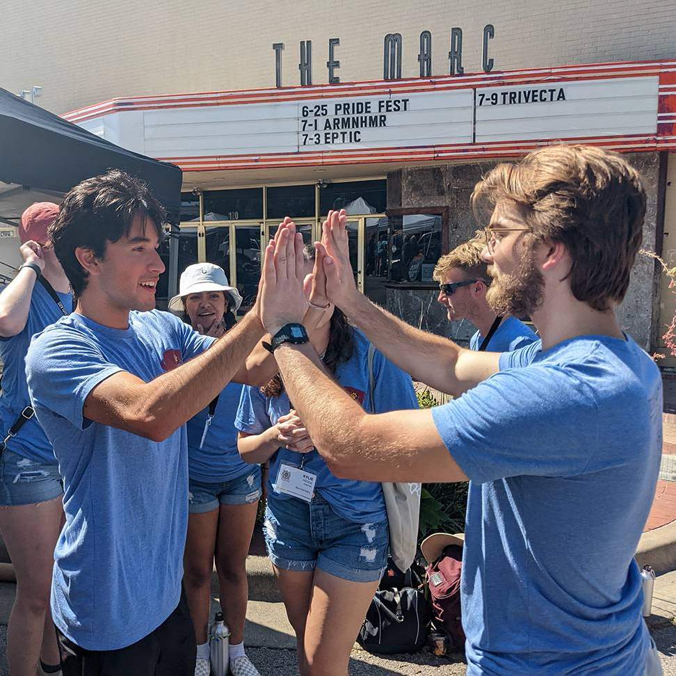 male students high-fiving