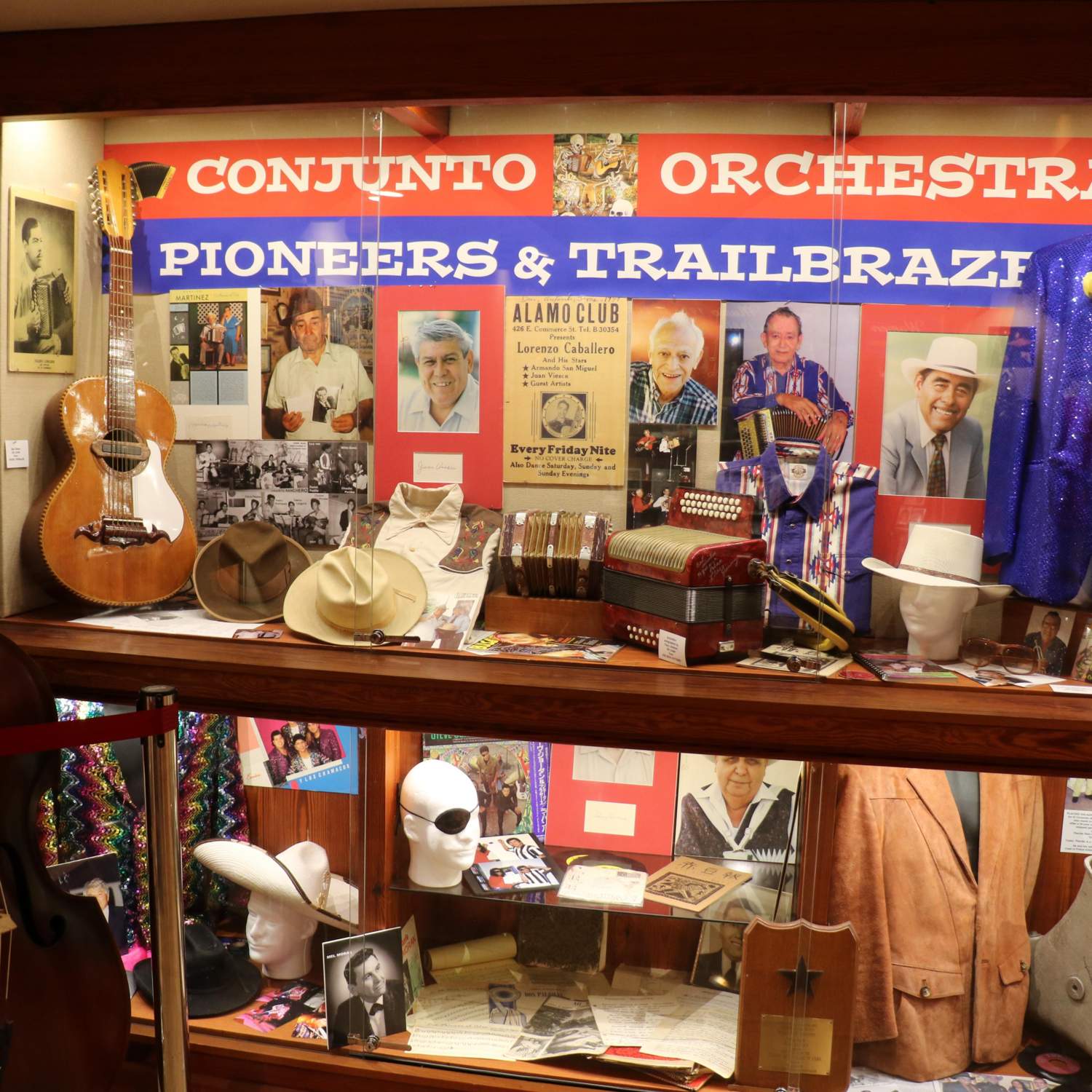 Photo of display case titled "Conjunto and Orchestra Pioneers and Trailblazers"