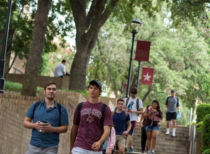 students walking on TXST campus